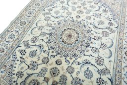 Backside of handmade New Nain rug showing knot structure and weave density