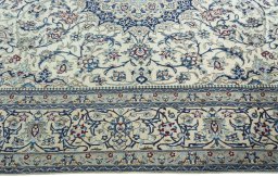 Corner detail of 2000s Nain rug showing border pattern and Wool pile
