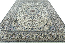 Surface texture of 2000s Nain rug with natural Wool and intricate pattern