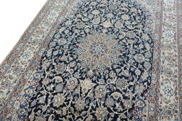 Backside of handmade 2000s Nain rug showing knot structure and weave density