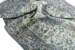 Surface texture of Unknown Nain rug with natural Wool and intricate pattern