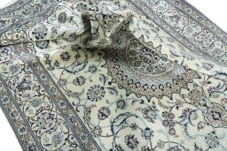 Surface texture of 2000s Nain rug with natural Wool and intricate pattern