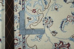 Surface texture of 2000s Nain rug with natural Wool and intricate pattern