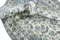 Surface texture of 2000s Nain rug with natural Wool and intricate pattern