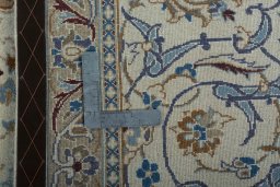 Backside of handmade 2000s Nain rug showing knot structure and weave density