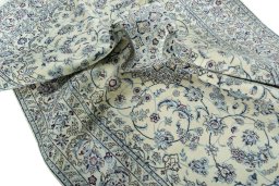 Surface texture of 2000s Nain rug with natural Wool and intricate pattern