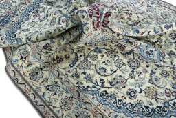 Surface texture of 2000s Nain rug with natural Wool and intricate pattern