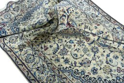 Surface texture of 2000s Nain rug with natural Wool and intricate pattern