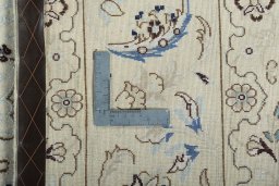 Backside of handmade New Nain rug showing knot structure and weave density