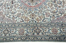 Corner detail of 2000s Nain rug showing border pattern and Wool pile