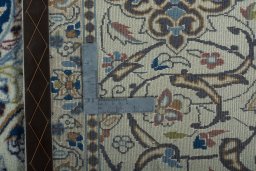 Backside of handmade 2000s Nain rug showing knot structure and weave density