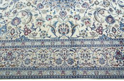 Corner detail of 2000s Nain rug showing border pattern and Wool pile