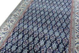 Backside of handmade New Nain rug showing knot structure and weave density