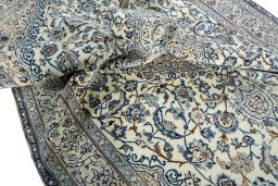Surface texture of 2000s Nain rug with natural Wool and intricate pattern