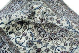 Surface texture of 2000s Nain rug with natural Wool and intricate pattern