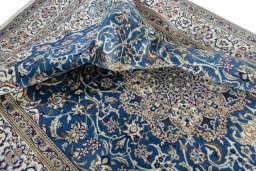 Surface texture of 2000s Nain rug with natural Wool and intricate pattern