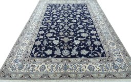 Surface texture of 2000s Nain rug with natural Wool and intricate pattern