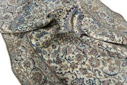 Surface texture of 2000s Nain rug with natural Wool and intricate pattern
