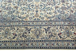 Corner detail of 2000s Nain rug showing border pattern and Wool pile