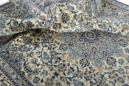 Surface texture of 2000s Nain rug with natural Wool and intricate pattern