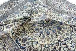 Surface texture of 2000s Nain rug with natural Wool and intricate pattern