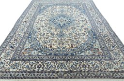 Surface texture of 2000s Nain rug with natural Wool and intricate pattern