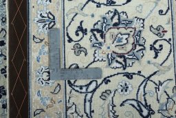 Backside of handmade New Nain rug showing knot structure and weave density