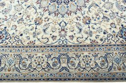 Corner detail of 2000s Nain rug showing border pattern and Wool pile