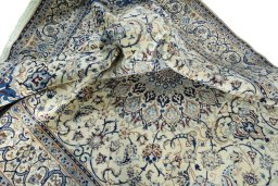 Surface texture of 2000s Nain rug with natural Wool and intricate pattern