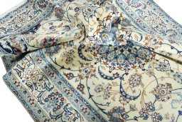 Surface texture of 2000s Nain rug with natural Wool and intricate pattern
