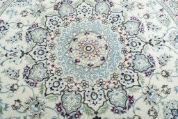 Backside of handmade New Nain rug showing knot structure and weave density