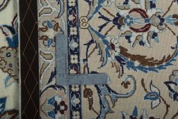 Backside of handmade New Nain rug showing knot structure and weave density