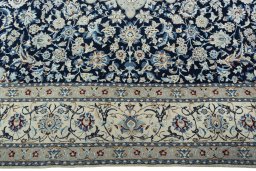 Corner detail of 2000s Nain rug showing border pattern and Wool pile