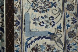 Backside of handmade New Nain rug showing knot structure and weave density