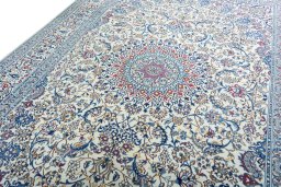 Backside of handmade New Nain rug showing knot structure and weave density