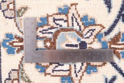 Surface texture of 1985s Nain rug with natural Wool and intricate pattern