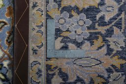 Backside of handmade 2000s Najafabad rug showing knot structure and weave density