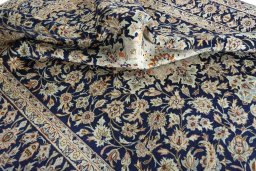 Surface texture of 2000s Najafabad rug with natural Wool and intricate pattern