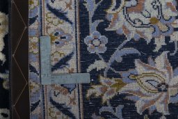 Backside of handmade New Najafabad rug showing knot structure and weave density