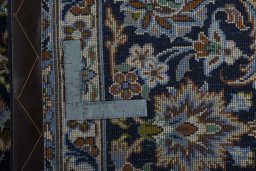 Backside of handmade 2000s Najafabad rug showing knot structure and weave density