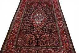 Surface texture of 2000s Sarough rug with natural Wool and intricate pattern