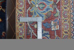 Backside of handmade 1970s Sarough rug showing knot structure and weave density