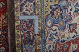 Backside of handmade New Sarough rug showing knot structure and weave density