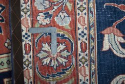 Backside of handmade New Sarough rug showing knot structure and weave density