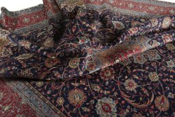 Surface texture of 2000s Sarough rug with natural Wool and intricate pattern