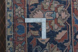Backside of handmade 1930s Sarough rug showing knot structure and weave density