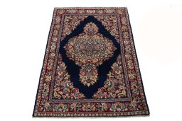 Surface texture of 2000s Sarough rug with natural Wool and intricate pattern