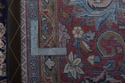 Backside of handmade 1970s Sarough rug showing knot structure and weave density