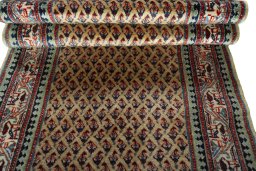 Full view of 1970s Sarough Mir rug from Iran / Persia, 616 × 87 cm in Beige tones