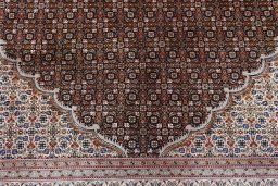 Corner detail of 2000s Tabriz rug showing border pattern and Cork pile